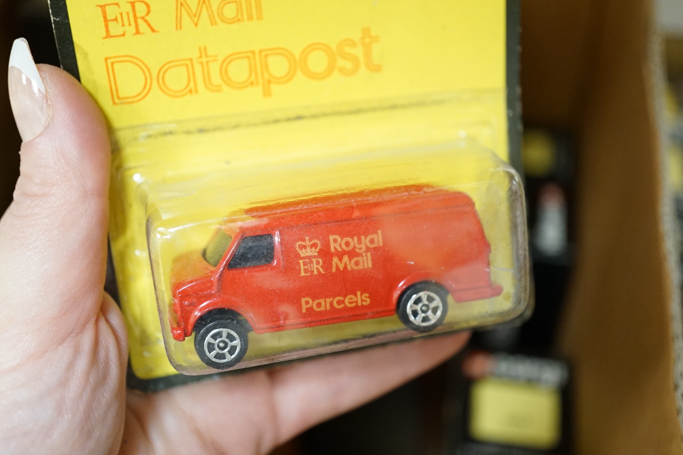 Sixty-six 1980's Corgi Toys Royal Mail vehicles, all boxed or packeted, together with an original ‘point of sale’ Post Office display cabinet for this series of vehicles containing unboxed display examples